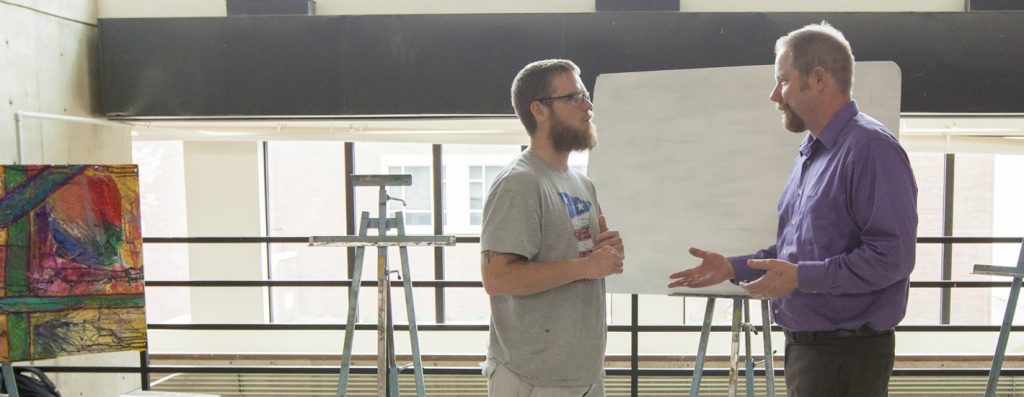 Simon Huelsbeck, Art Instructor, Talking with 易胜博 Student