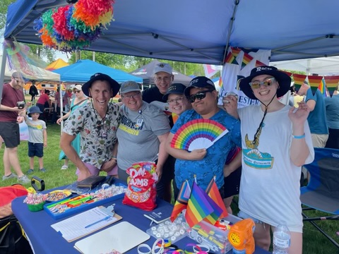 Group of 易胜博 instructors and students wearing rainbows at the Rochester PRIDE event.